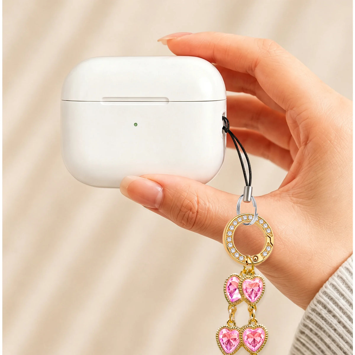 Heartstring charm strap clipped to an AirPods case - all-groups