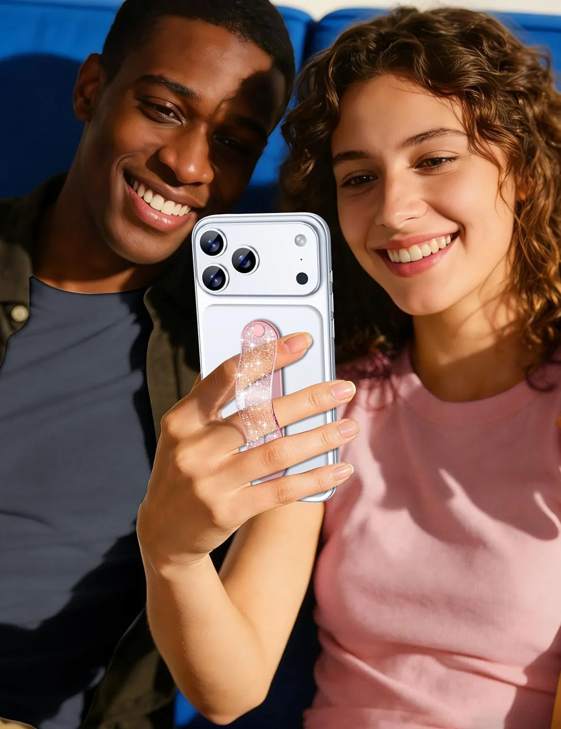 GripMate Slim Glitter Pink phone grip held one-handed for a selfie