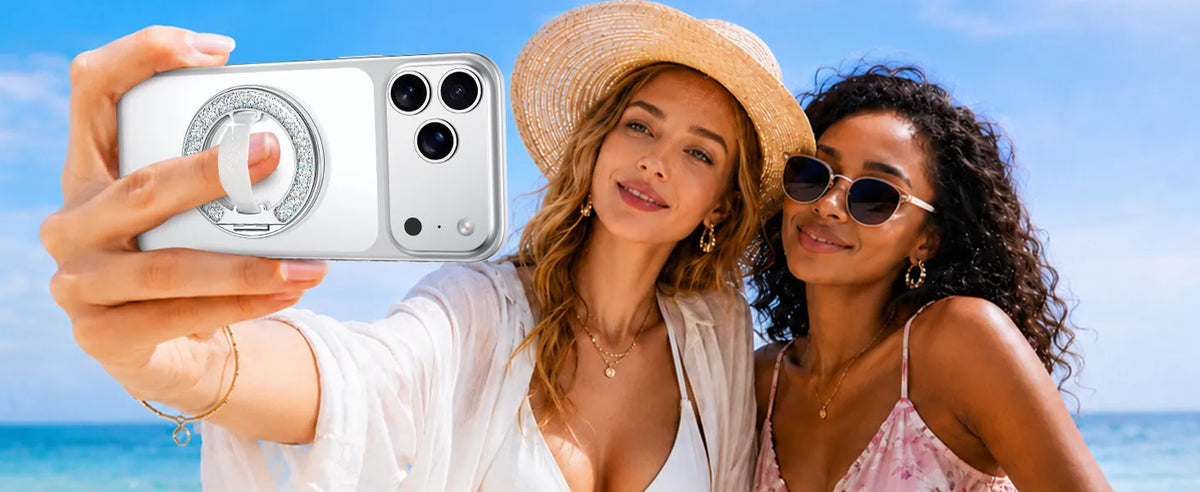 Two friends taking a beach selfie with a GripMate Ring in Glitter Silver on their phone