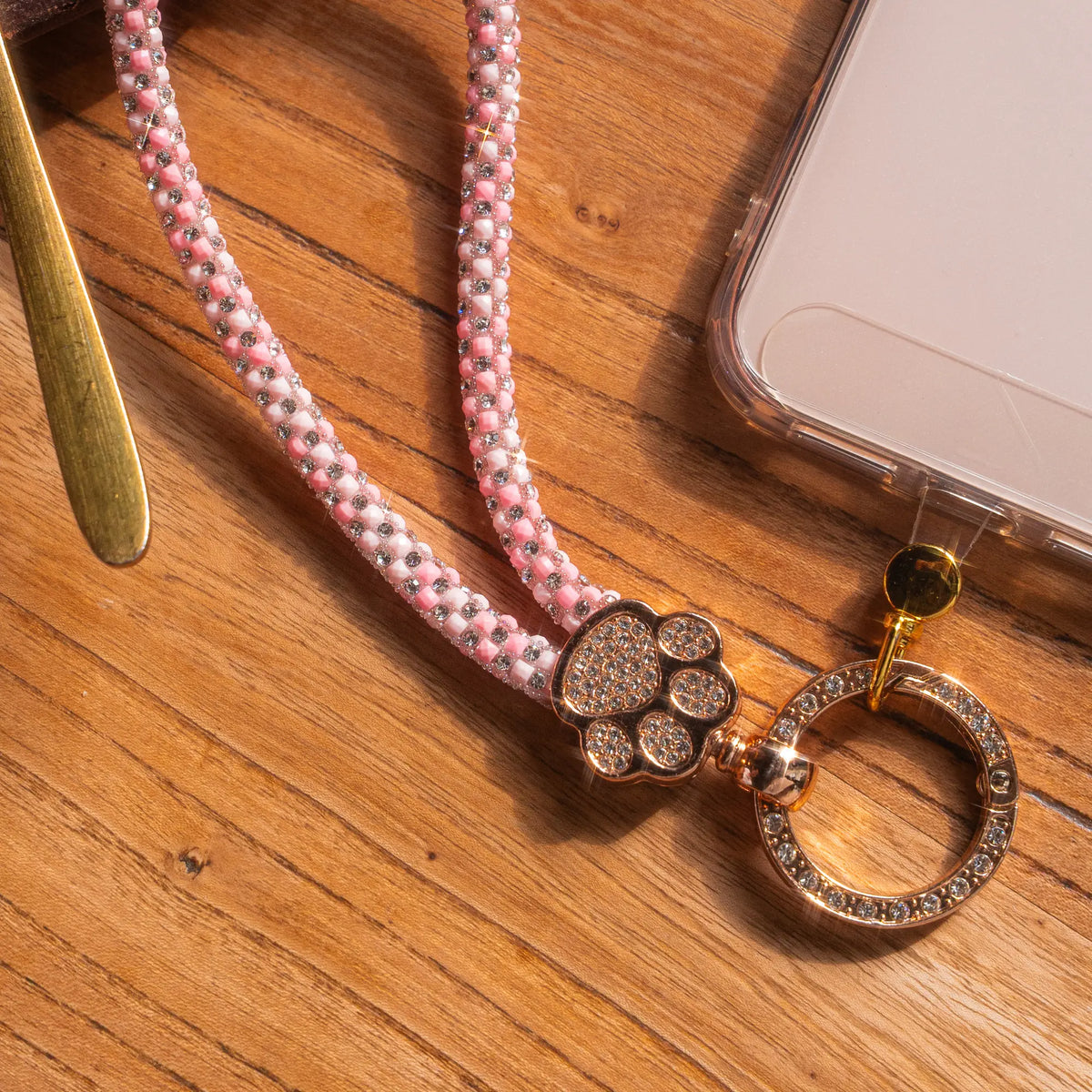 Pawfect charm strap in Pink, flat lay with phone - all-groups